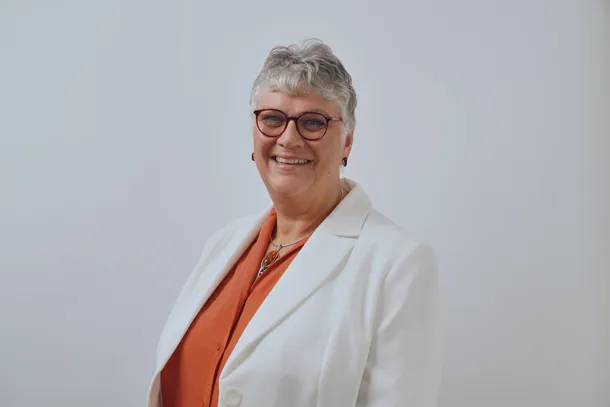 A professional photograph of Louise Evans smiling at the camera.