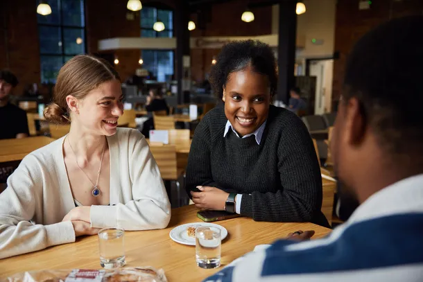 A group of students sat in Crawshays smiling and talking