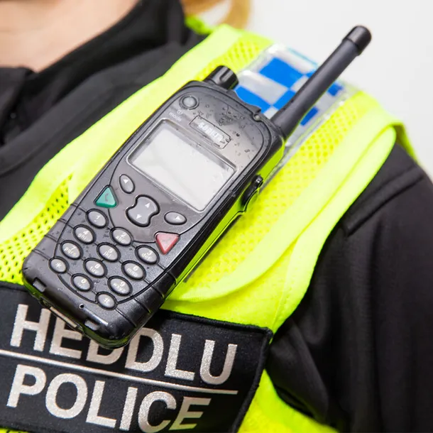 Police officer wearing a high-vis and walkie talkie