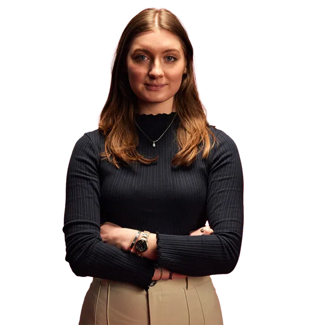 Business graduate, Agnelle, stood with arms crossed smiling at the camera.
