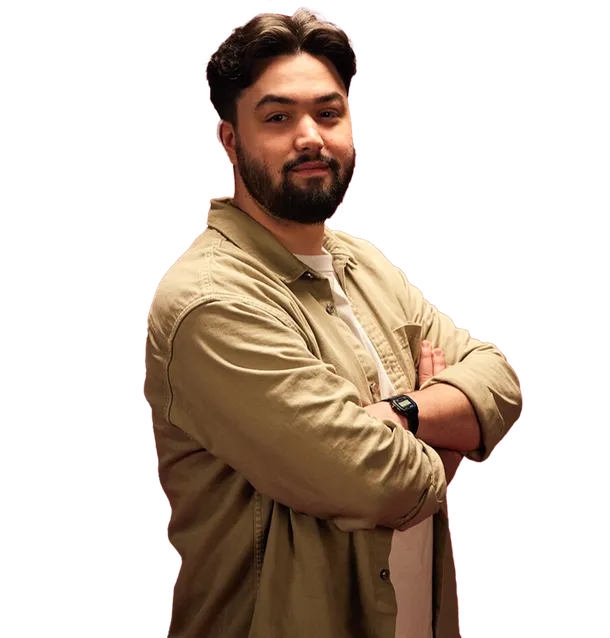 Savva, a Cyber Security graduate, stood with arms crossed smiling at the camera.