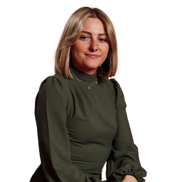 Human Resource Management graduate, Zoe, is sat looking and smiling at the camera.