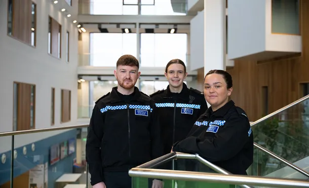 Three Policing students pose for a photo in their uniforms