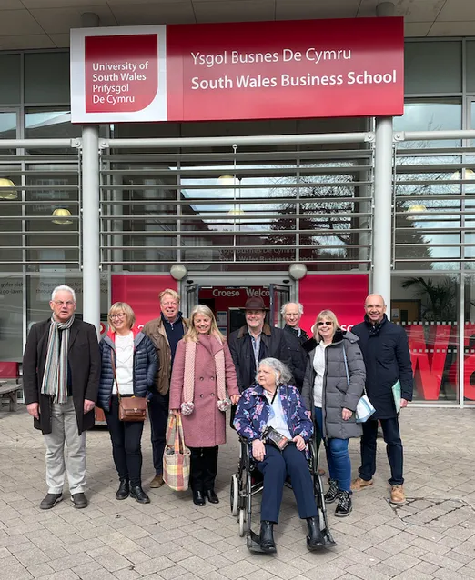 A group photo of USW Alumni gathered outside of the South Wales Business School.