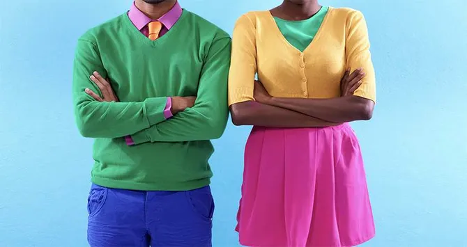 Two people stood together wearing clothes of various different colours