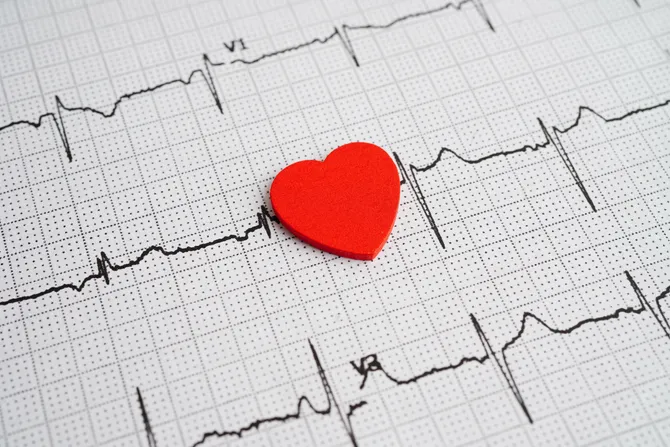heart monitor diagram with a red love heart cut placed on top