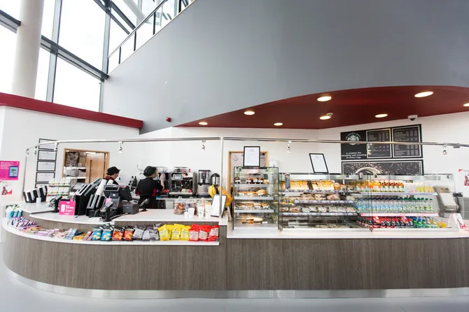 The Starbucks kiosk at the Newport campus with various cakes, crisps and drinks on display.