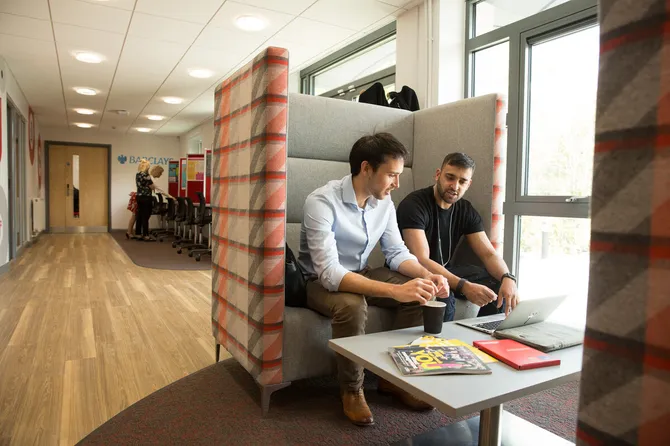 Two men sat in booth seating in the usw exchange.