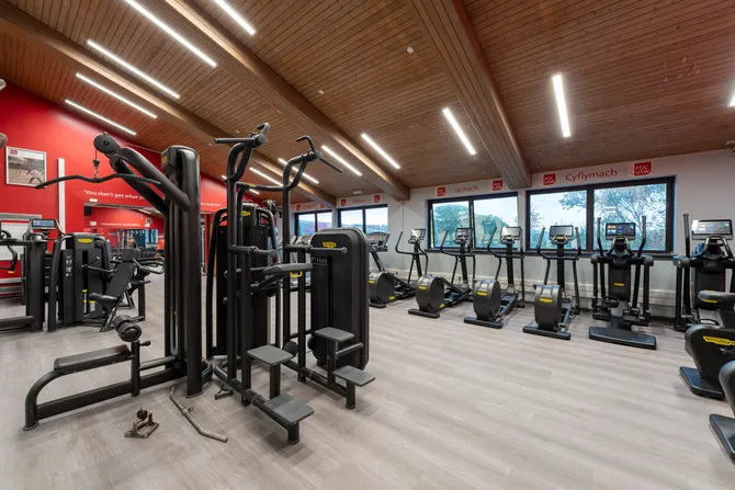 FitZone gym in Pontypridd - An equipped gym interior with various exercise machines under bright lighting.