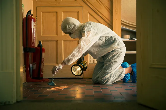 Forensic student conducting a crime scene training scenario.