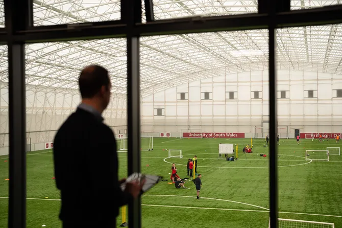 Onlooker analysing a football game at the University Sport Park.