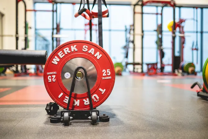 The Strength and Conditioning Centre with a red and black weight on the floor.