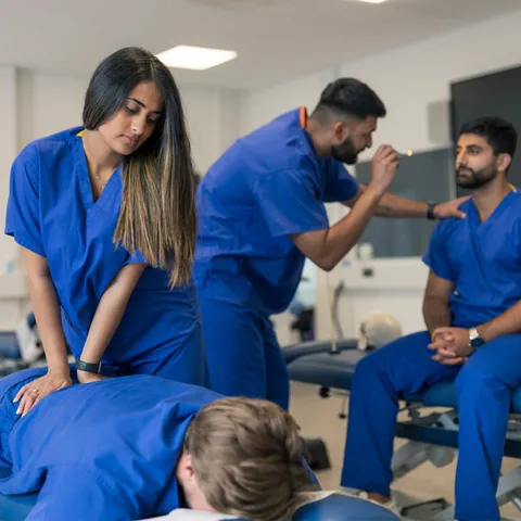 Two students treating other students at the chiropractic clinic