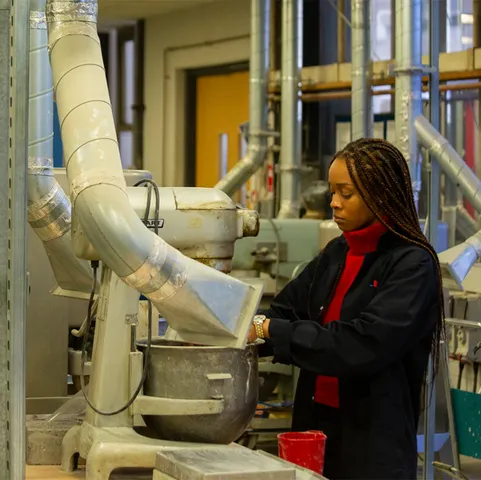 A student mixes components in an industrial mixer in a USW Treforest workroom