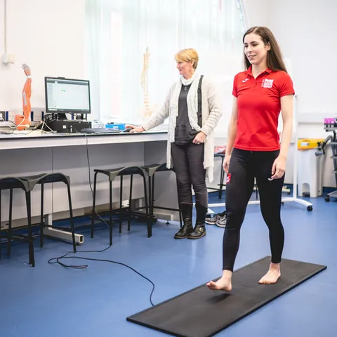 A USW student and lecturer in a exercise therapy practical session.