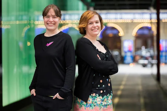 Graduates Catherine and Charlotte Woolley smiling together