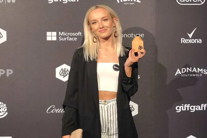 Graphic Communication graduate Kate poses for a photo after winning the Pencil Award at the D&AD New Blood Awards, 2019