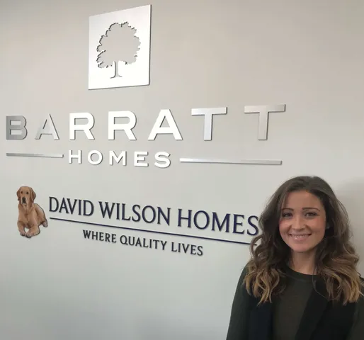 Network75 student Claudia Schiavo standing in front of Barratt homes logo