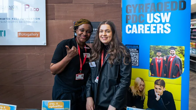 two members of usw enterprise team staff standing at a stall at the enterprise 2023 event