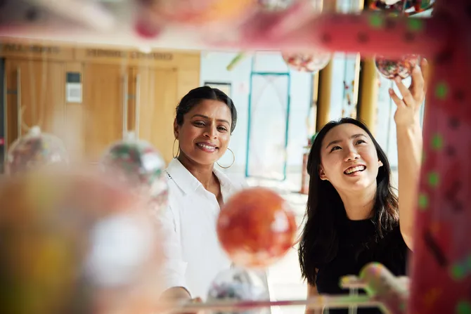 Two students smiling and exploring the area surrounding Newport City Campus.