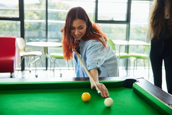 A student playing pool in the students union.