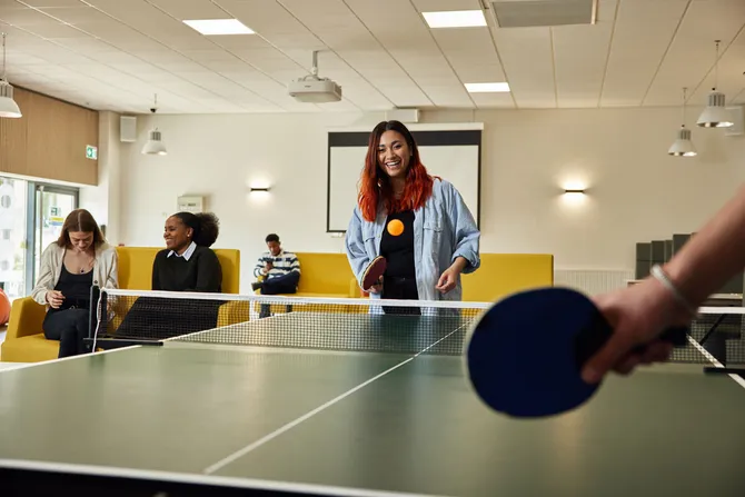 Students playing a game of pingpong in the accommodation hub.