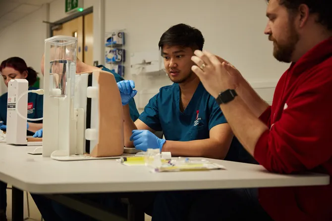 ODP students racticing how to find veins on a activity dummy.