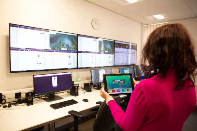 person holding ipad in front of hydra simulation centre