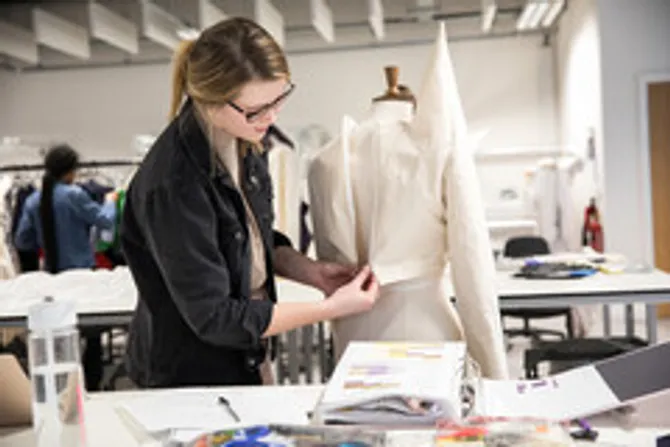 A student is working on a tailors mannequin.