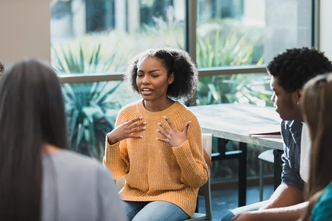 A person sharing their thoughts during a group support session