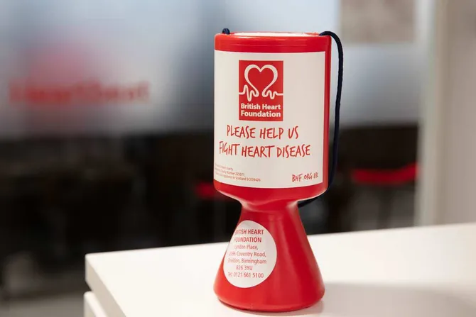 British Heart Foundation collection pot sitting on a white table