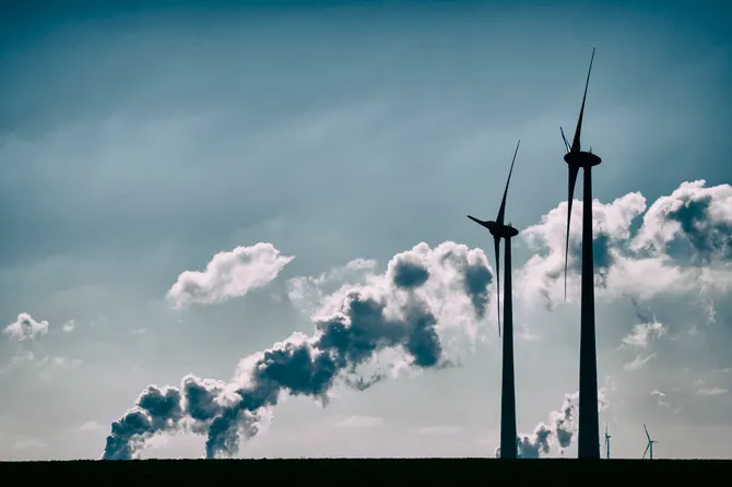 Silhouettes of two wind turbines