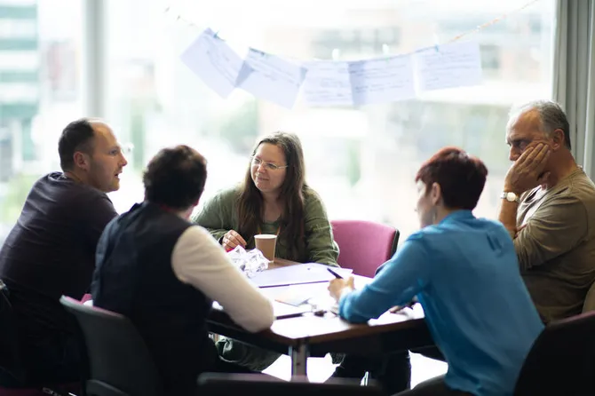 A group of researchers sat around a table having a discussion.