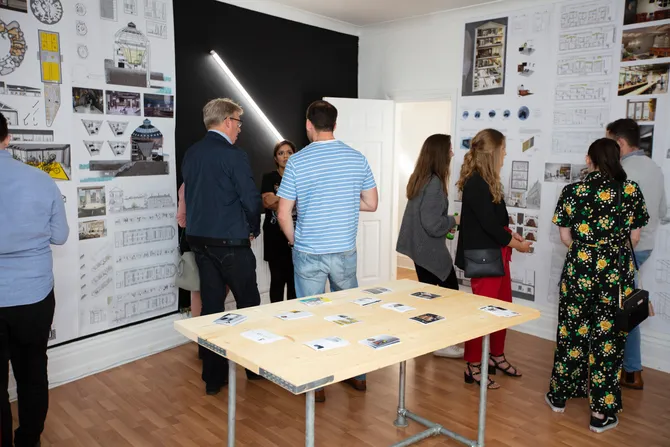 Students look around an exhibition showcasing interior design coursework and designs at the Cardiff campus