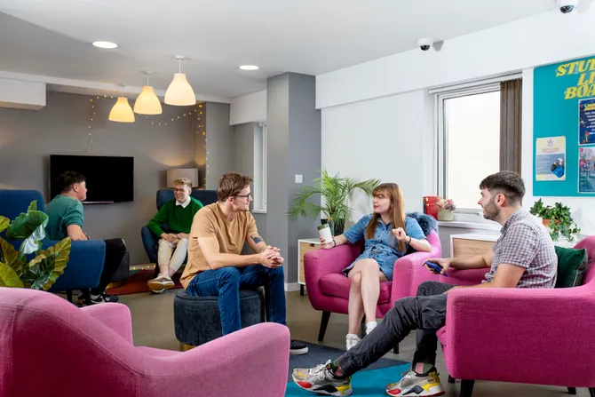 A group of students socialising in the common area of student accommodation in Cardiff