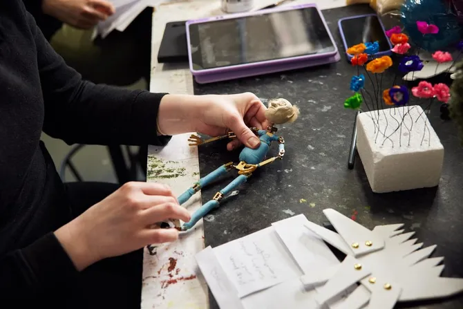 animation student working on a clay sculpture