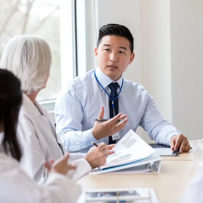 A medical professional talking during a meeting