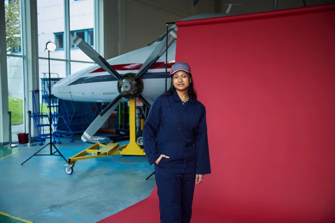 Aircraft engineering student posing for camera in front of the USW aircraft