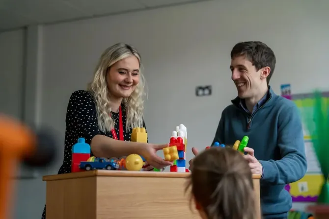 two members of the aba clinic staff working with a child