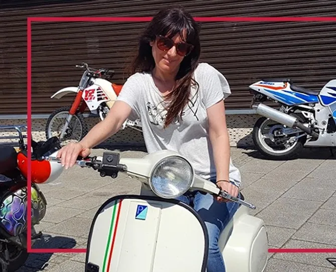 Professor Fiona Brookman sitting on a white motorised scooter
