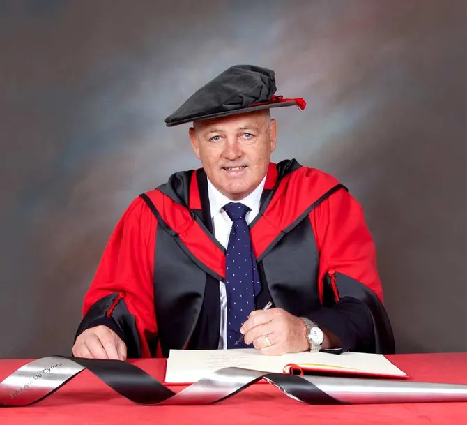 Warren Gatland CBE smiling in cap and gown
