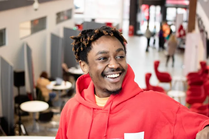 A student ambassador smiling off camera