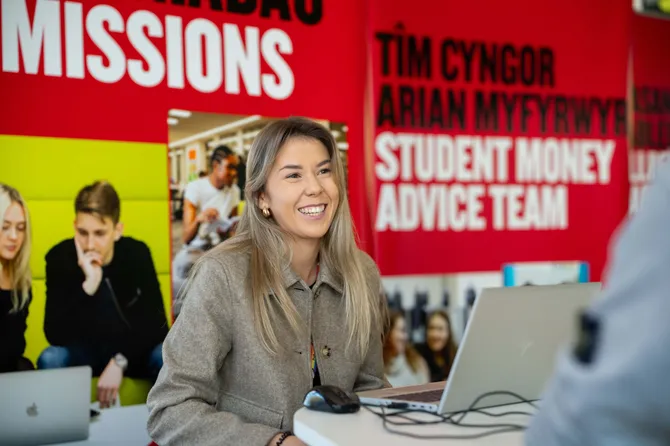 A member of USW staff supporting students with admissions advice at an open day.