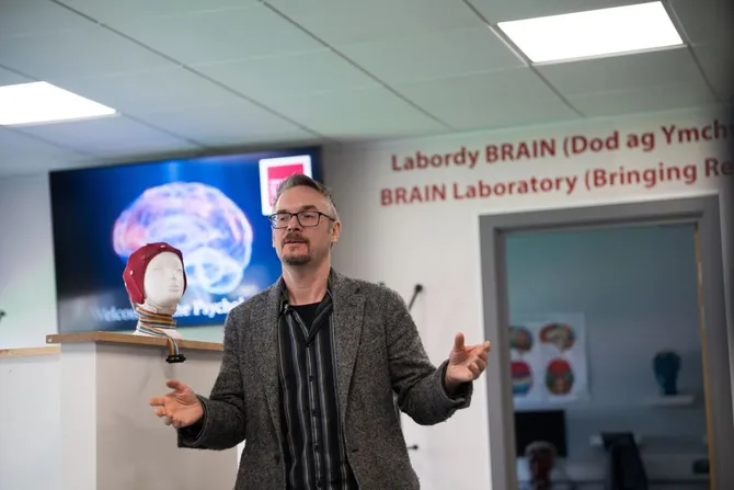 A Psychology lecturer presenting a welcome talk to open day visitors