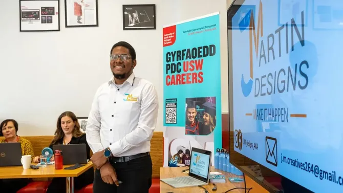 USW Careers staff standing in front of a USW Careers presentation screen