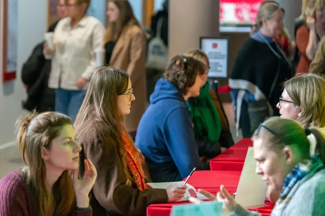 Prospective students are sat opposite a lecturers at a Postgraduate Open Event, getting advice about USW courses.