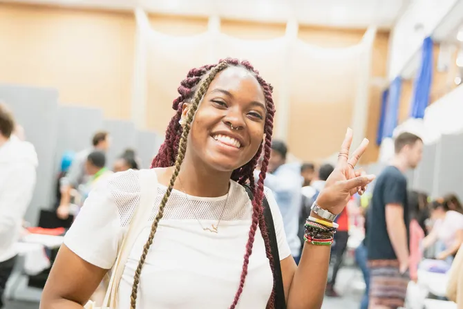 Student smiling and giving a peace sign at Treforest Welcome Week