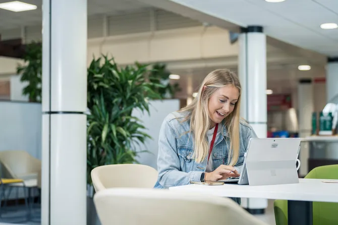 student sat on a laptop working in Stilts, Treforest