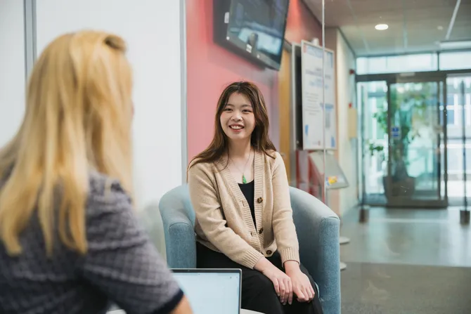 Student sat in USW Careers Service office talking to a Careers Consultant