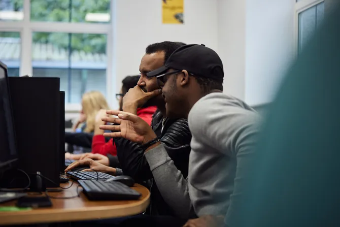 Two Accounting students working together at computer